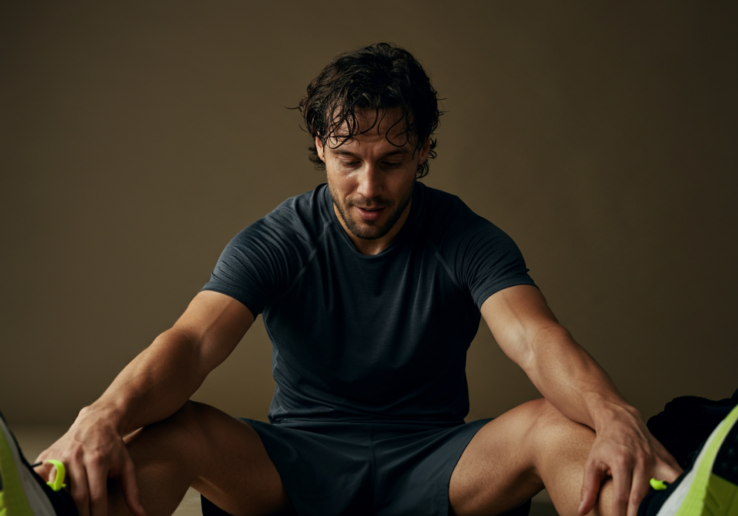 A focused athlete performing gentle recovery exercises or stretching, emphasizing the process of muscle repair and reduced inflammation.