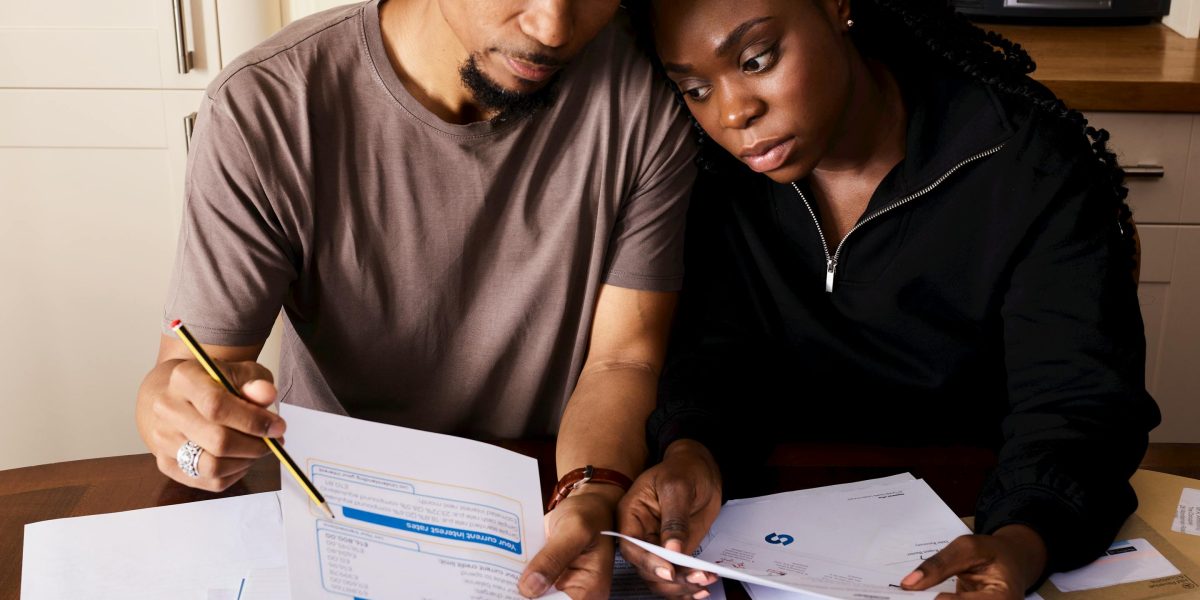 A family thoughtfully discussing their budget and financial planning at home.