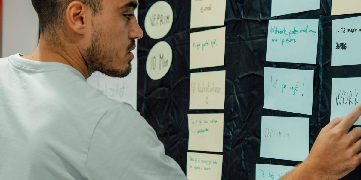 An individual meticulously planning the various aspects of a new gym launch, from concept to operations.