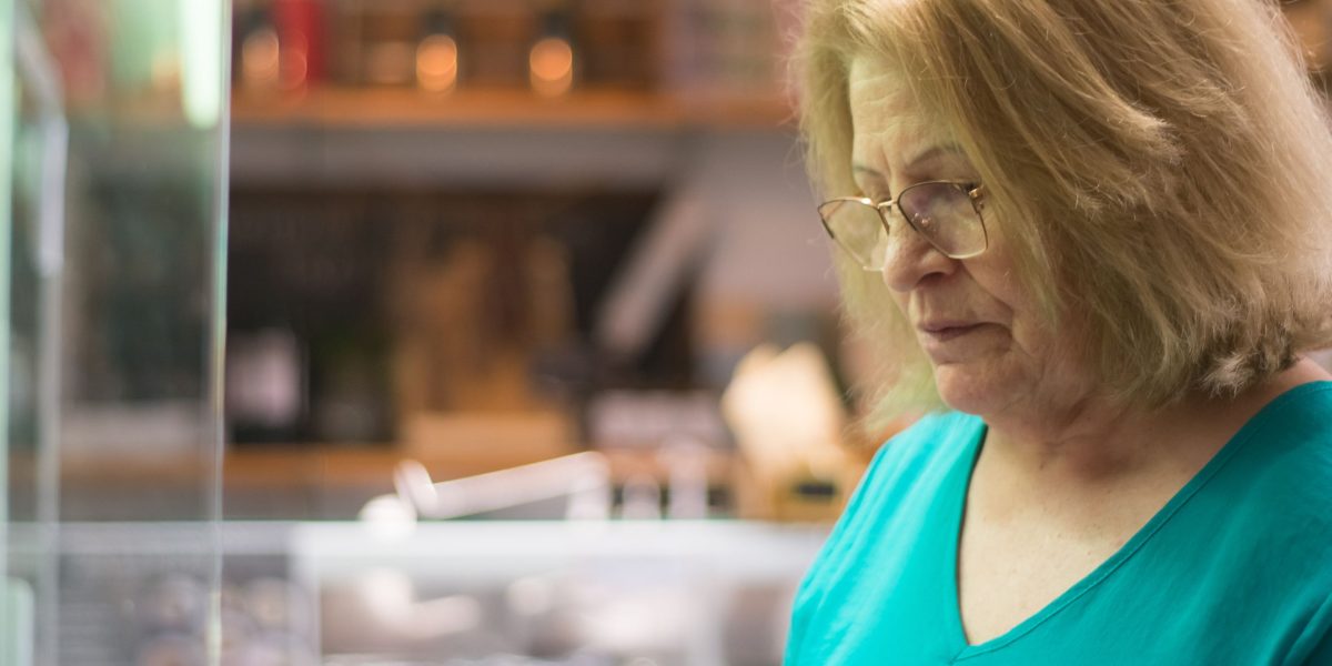 A person carefully examining a product label, focusing on ingredients and details.