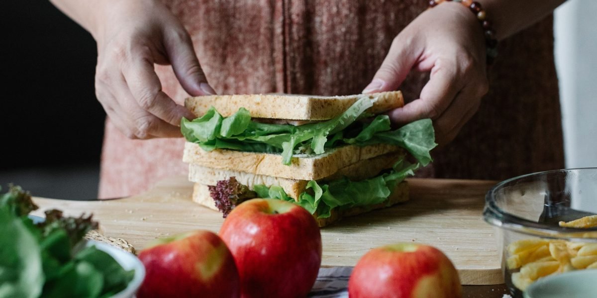 A person preparing a nutritious meal, symbolizing the importance of diet in muscle recovery and growth.