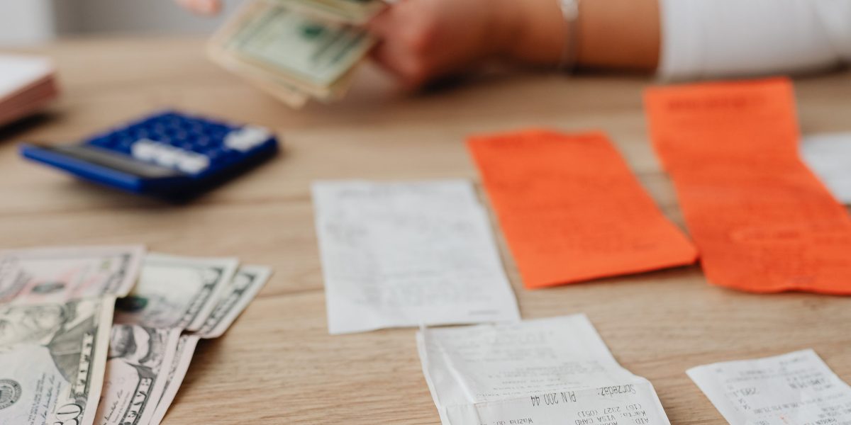 Someone carefully examining financial statements or bills, reflecting the concern over monthly premium costs.