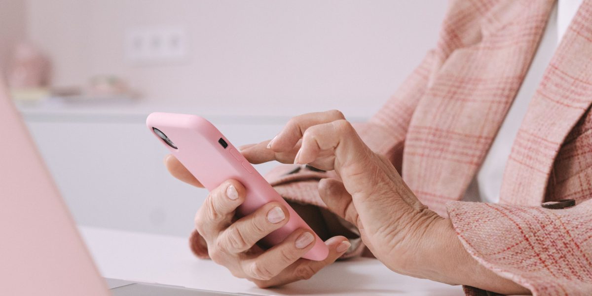 An individual reading on a tablet or laptop, engaged in researching online customer feedback before making a choice.